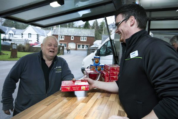 Mayor of Appleby Hughie Potts is served by Co-op manager Ian Peacock at the pop-up store in Appleby in Westmorland, Cumbria