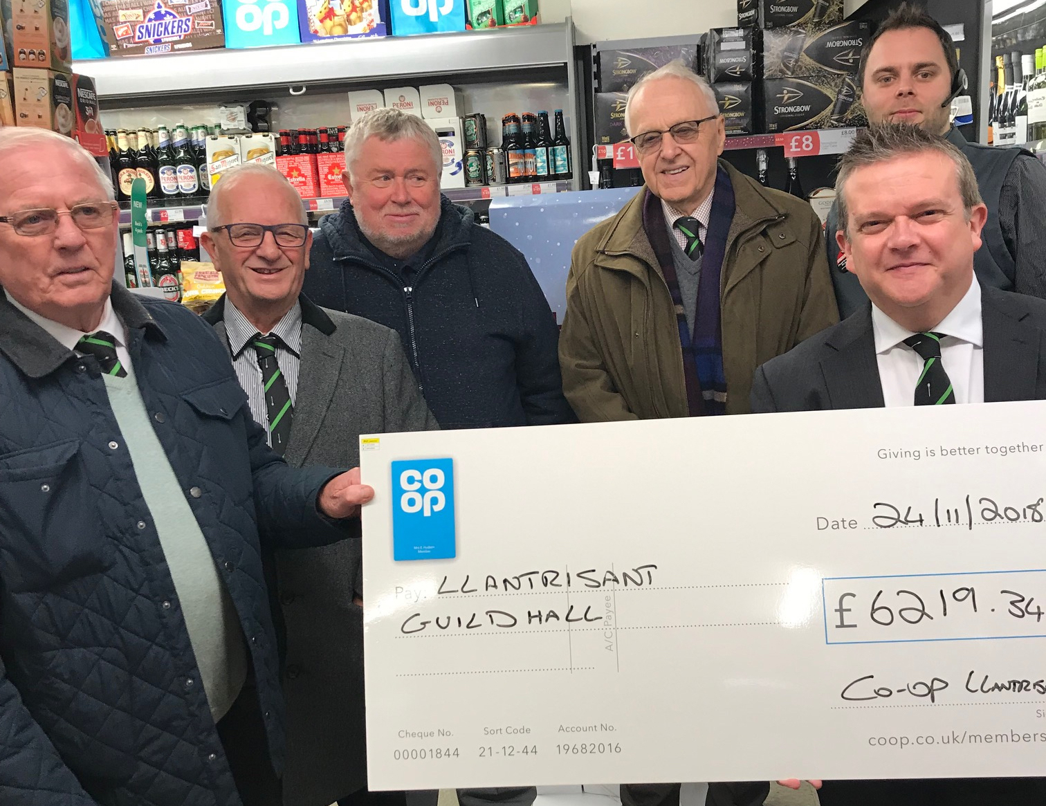 The donation is handed over at a Co-op Group store