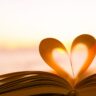 Heart from a book page against a beautiful sunset.